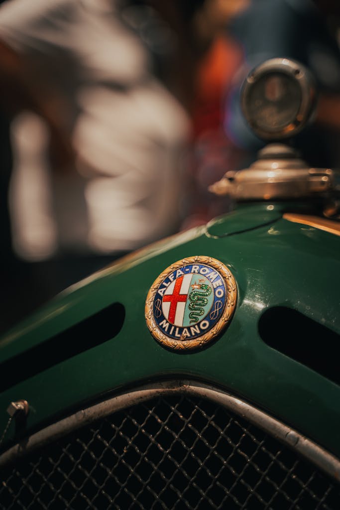 Close-up of a vintage Alfa Romeo car emblem, capturing nostalgic retro details.