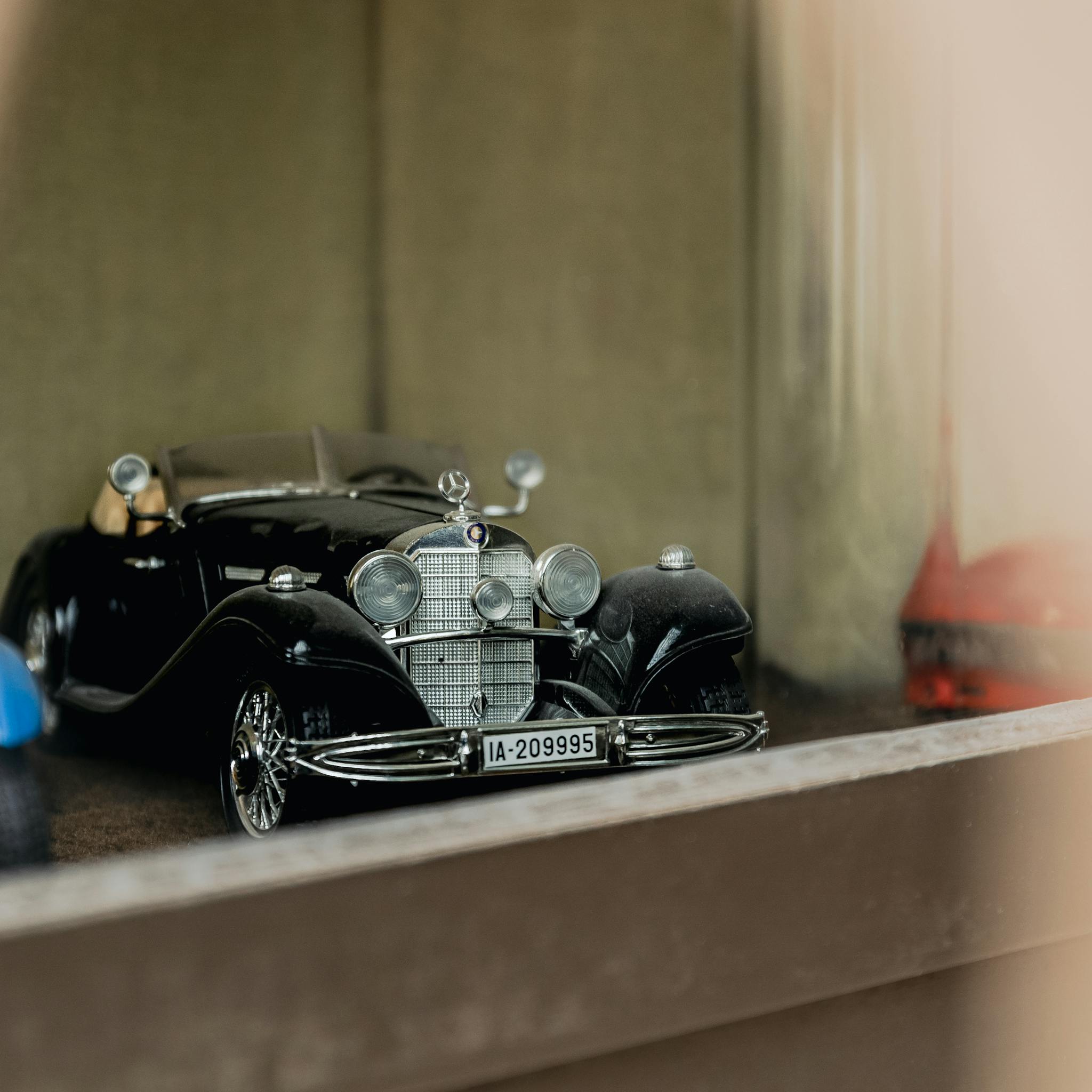 Close-up of a vintage black toy car showcasing intricate details in Stuttgart, Germany.