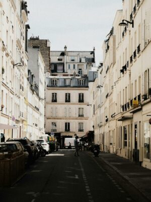 Elegant view of a Parisian street showcasing classic architecture with soft afternoon light.