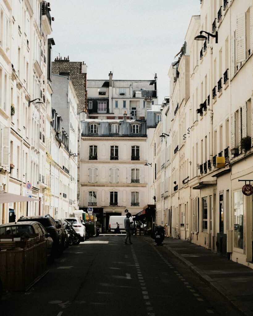 Elegant view of a Parisian street showcasing classic architecture with soft afternoon light.